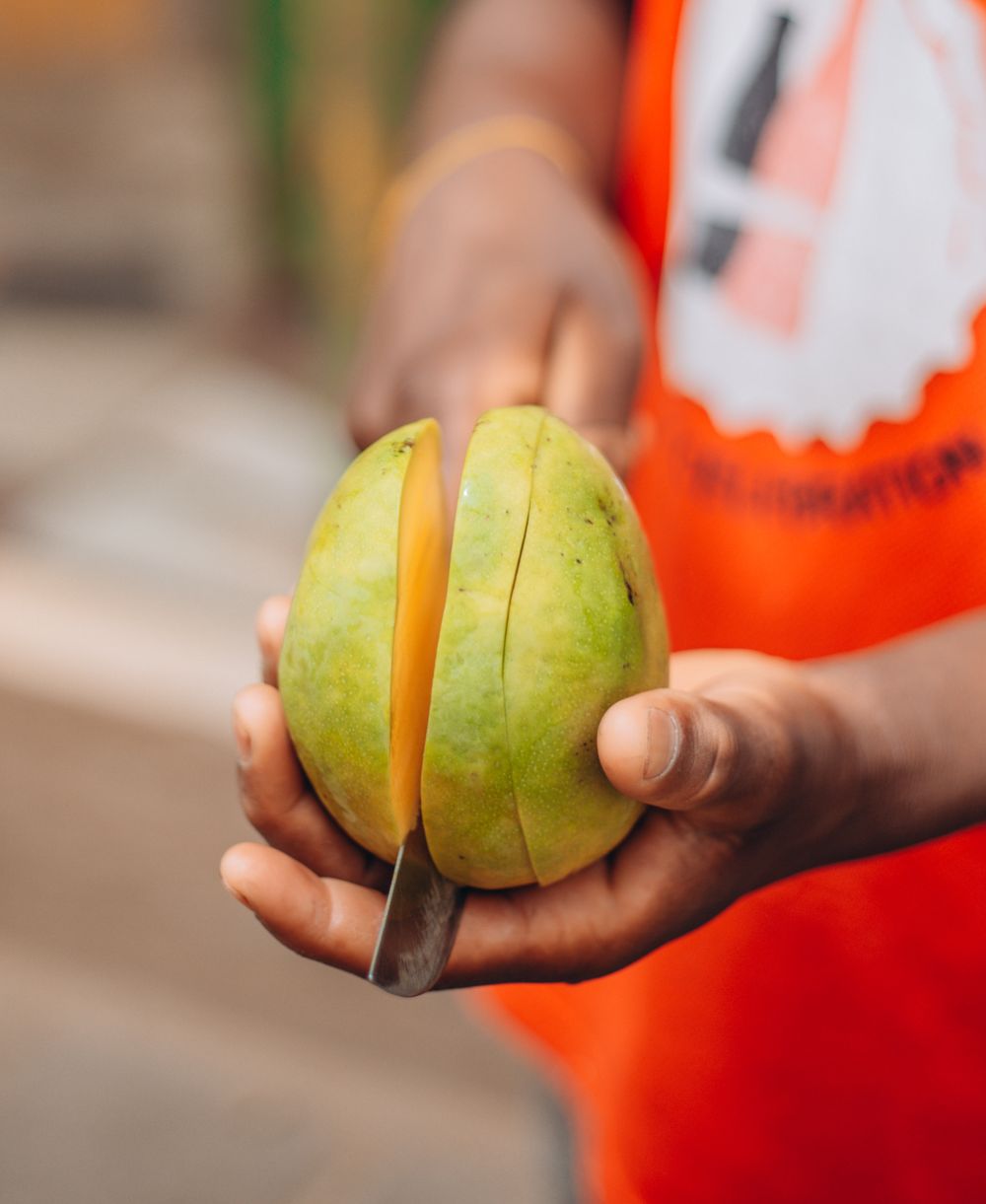 Hands cutting a fresh mango
