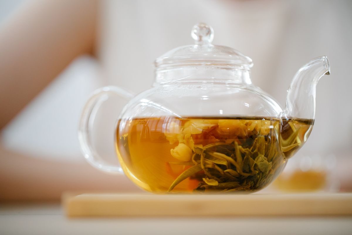 Amber tea brewing in a clear glass teapot